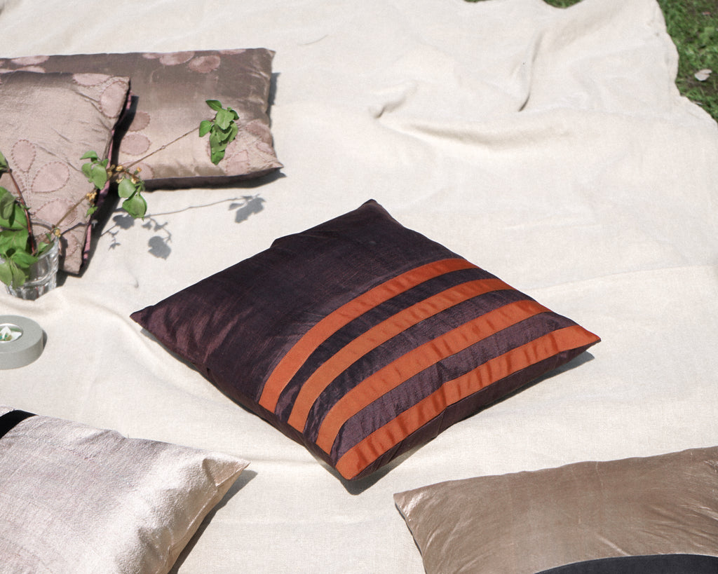 Minimalist and elegant are called for this silk cushion. The plain brown silk with cotton stripes across the body give a contemporary and classic look to the cushion itself and to the room.   Thanks to its standard size which can be used with most of the cushions in your home.  Cushion cover size 40 x 40 cm. Cushion pad is not included