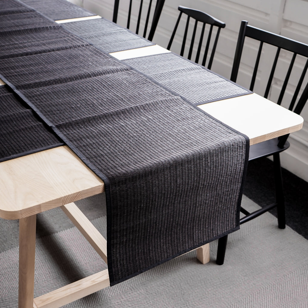 Table runner is the master piece on the dining table. Creating a modern, yet authentic style and character to the table with this black reed table runner. Handmade and hand woven with the finest quality reeds giving it beautiful and natural touch. Smooth the edge with a cotton trim. Perfect for a long table for 6-8 people. 