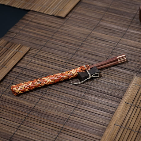 Experience the art of eating with a set of handmade wooden chopsticks with matching rest and case. Chopsticks and rest are handmade from wood with a natural wooden colour. Finished with a hand polish for a touch of a natural shine. Keep them organised in a case a hand woven rattan holder.  Suitable for hot or cold food. Ideal gift and home use. Handmade and fair trade product. 